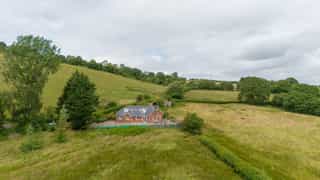 Aerial view of Castle View Lodge and the surrounding hills